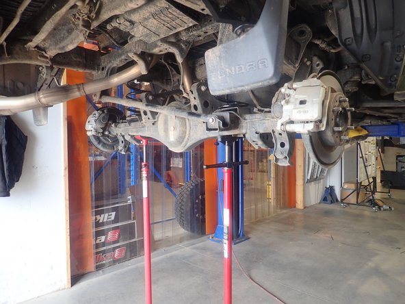 Lift the vehicle off the ground, then remove the rear tires.