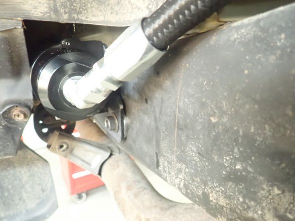 To avoid any interference  with wheels in fully compressed suspension situation, fix reservoir as far back as you can and turn it to put the hose closest to the frame possible as shown.