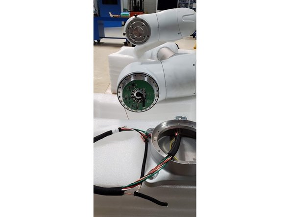 Unbolt the connector and last two cables attached to the base.