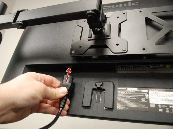 Insert the power cable into the back of the monitor.