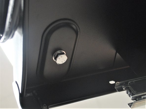 It helps if you hold the support plate against the shelf while you tighten the bolt.