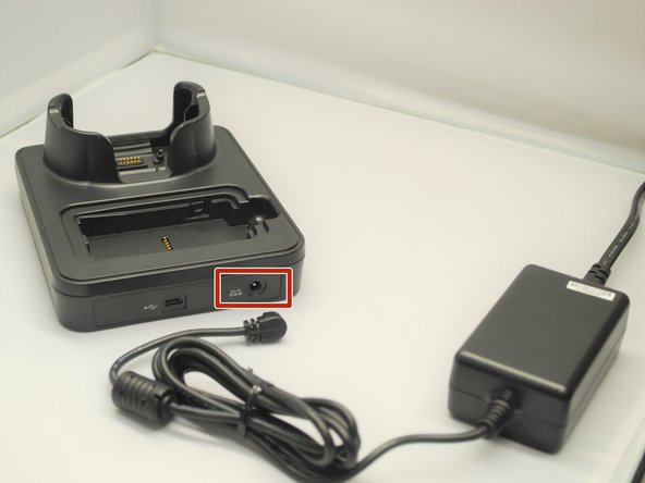 Once connected, plug the end of the other end of the AC Adapter into the cradle as shown.