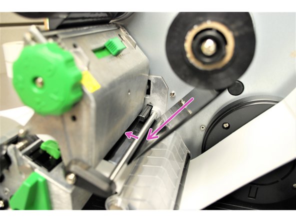 Feed the Ribbon through the Ribbon Sensor following the purple arrows in Image 3.