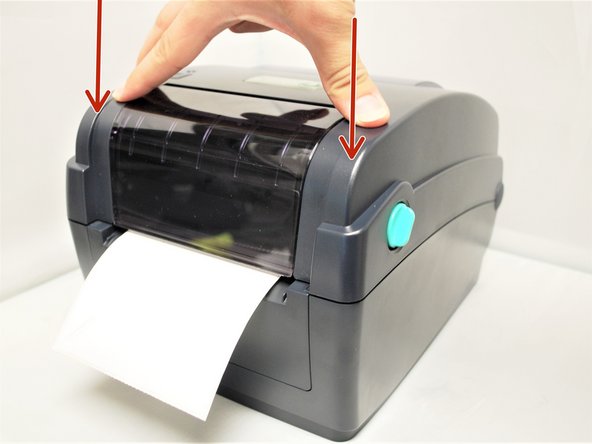 In the back right of the printer, push the green Top Cover Support in.