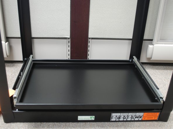 Insert the Keyboard Tray into the sliders and push it as far back as you can until fits into place.