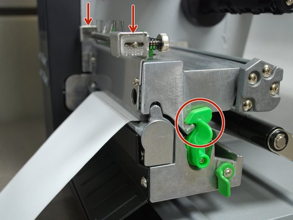 Close the printhead by pressing down firmly on top until you hear a 'click,' making sure that the green release lever is latched closed.