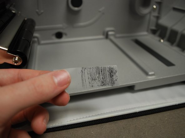 Put the piece of tape on the ribbon.