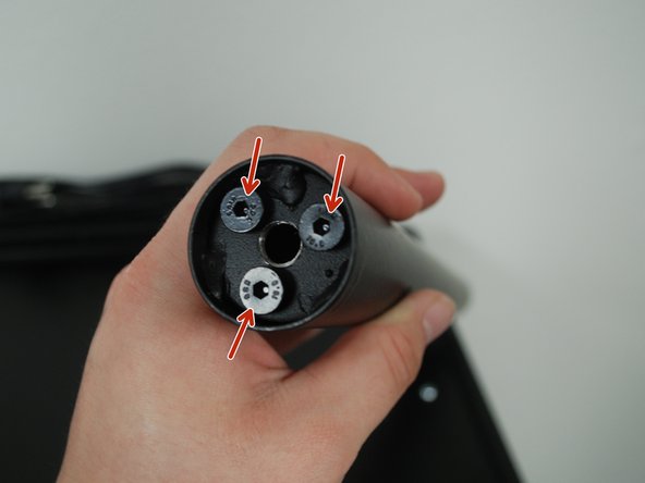 Identify the 3 bolts at the base of the support beam.