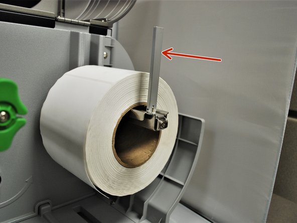 Fold the label roll guard back up and and press it against the side of the roll.