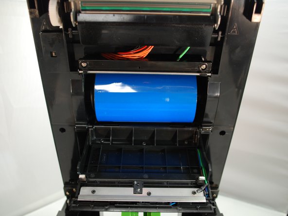 The ribbon should unspool from beneath the spindle, not from above.