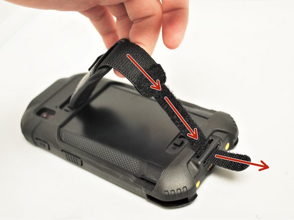 Pull the strap through the slot it's held in away the battery of the Mobile Computer.