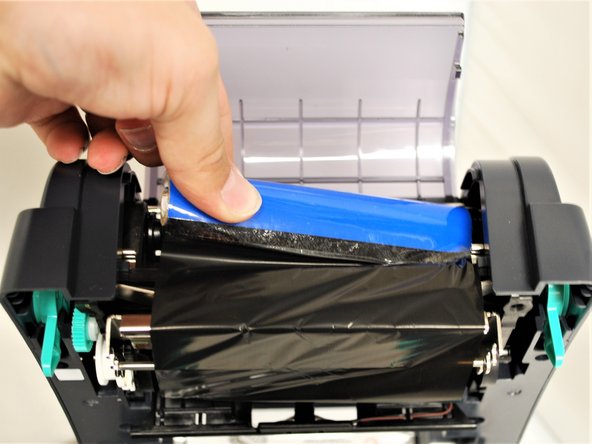 Much like loading the ribbon, load the core on the right first into the spring loaded holder.