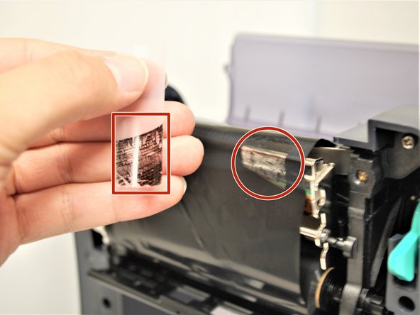 Put the piece of tape on the ribbon.