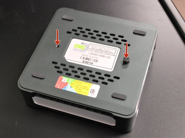 Attach the screws onto the back of the mini PC.