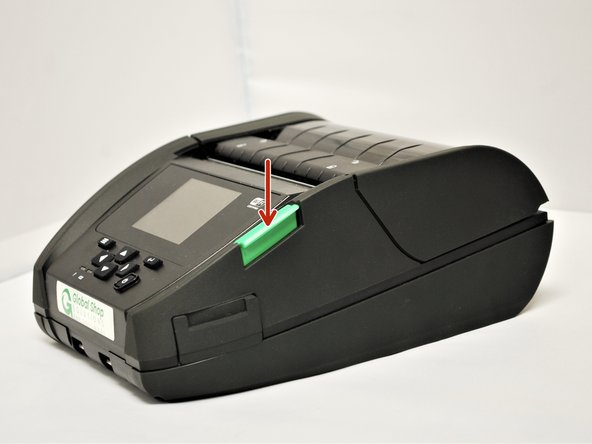 Open the printer by pressing down on the green media cover release button on the right side of the printer. The lid is spring loaded, and should pop open.