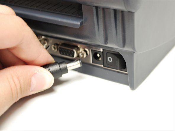 Connect the Printer Power Cord into the back of the printer in the power cord socket.