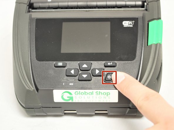 Press and hold the power button to turn on the printer.