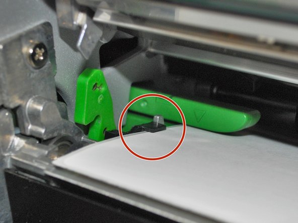 Make sure the far edge of the label roll lines up with the black clip at the back of the printer.