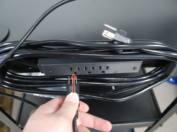 Plug the other end into the outlet behind the cart.