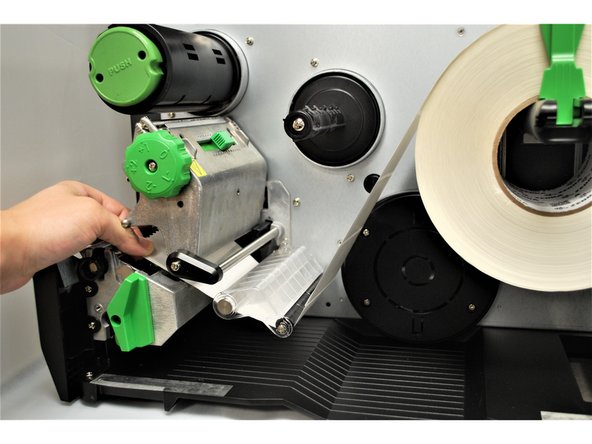 Feed the labels under the damper roller (1st picture).