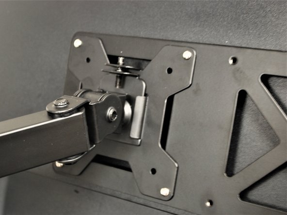 Slide the monitor VESA Plate over the Swivel Arm mount.