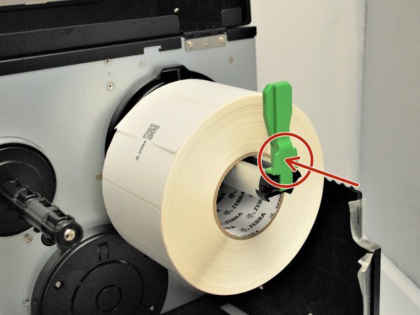 Fold the label roll guard back up.