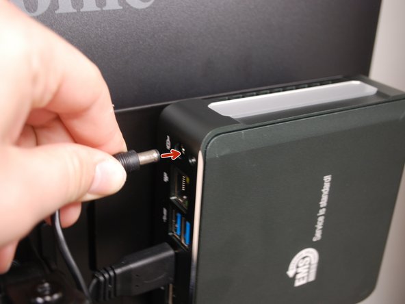 Plug the power cable into the Mini PC then into an outlet.