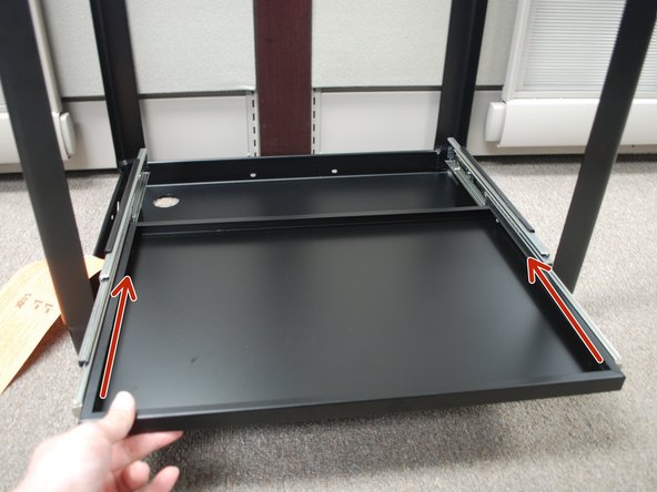 Insert the Keyboard Tray into the sliders and push it as far back as you can until fits into place.