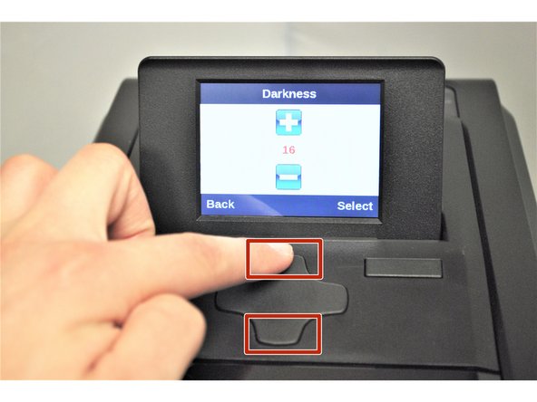 Press the up and down arrows on the directional pad to adjust the darkness as shown on the printer screen.