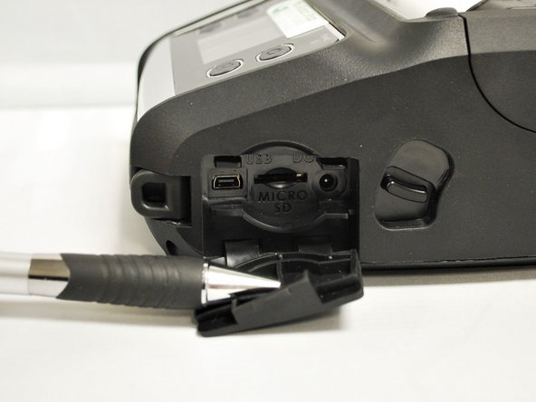 Open the rubber cover on the right side of the printer.