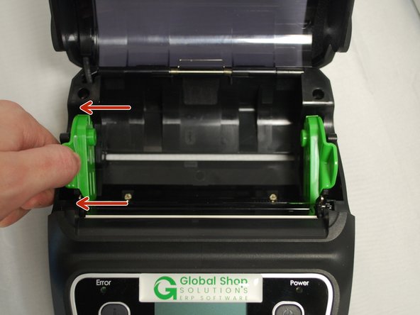 With one hand, pull the media holder open, and with the other hand load the roll of labels.