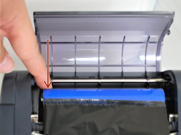 While holding it to the right, out the core into the holder on the left to hold it in place.