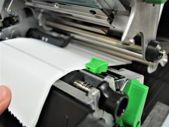 Slide the green front label guide forward until it fits against the close edge of the labels.