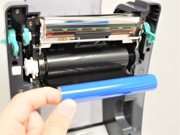 If it unwraps from the top, take the ribbon off and repeat the last step with it mounted in the other way.