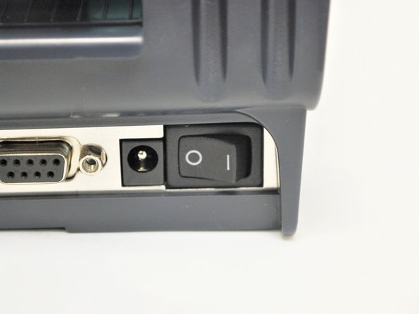 Take the plastic film off of the printer, and get the cables out of their packaging.