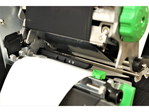 Slide the green front label guide forward until it fits against the close edge of the labels.