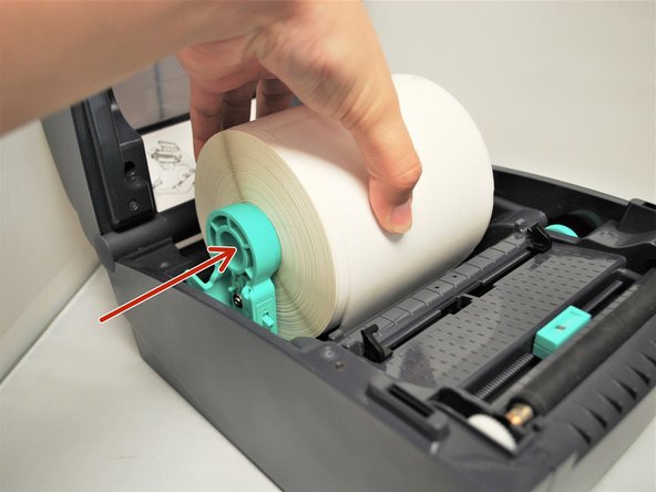 Use one hand to hold the roll of labels and place it on one holder