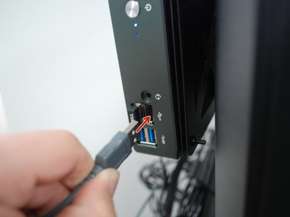 Plug the USB end of the USB adapter into the Mini PC