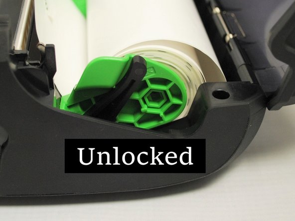 On either side of the media holders, there is a locking switch, to lock the holders into positions once the rolls are loaded.