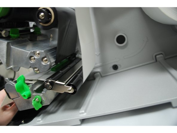 Feed the labels through/under the green media sensor bar.