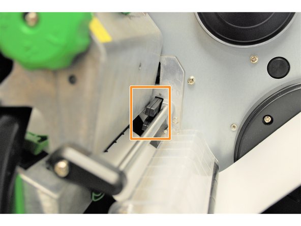 Identify the Ribbon Sensor located behind the printhead (shown by the orange box in Image 2).