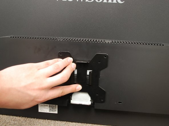 Identify the 4 screw holes on the back of the monitor.