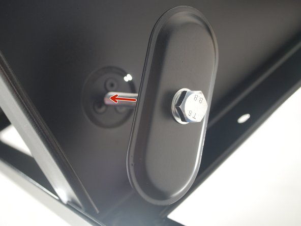 Begin to screw in the bolt to the center hole of the support beam using the wrench provided.