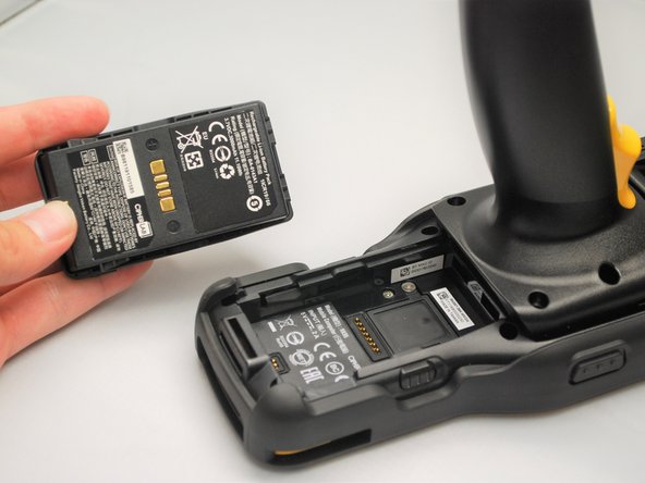 Squeeze the Battery Release Buttons on the left and right of the Mobile Computer to release the battery.