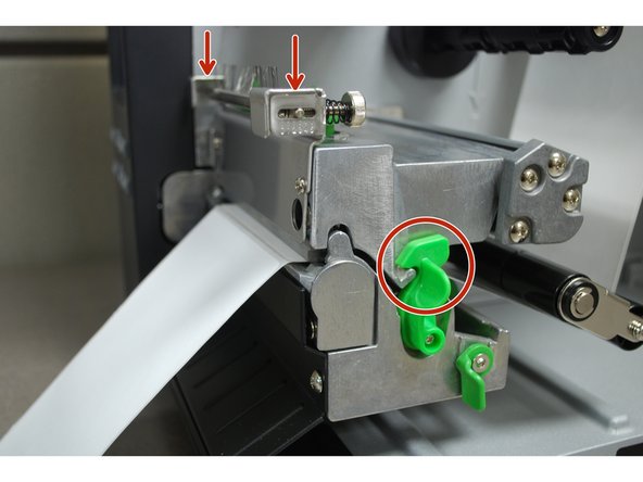 Close the printhead by pressing down firmly on top until you hear a 'click,' making sure that the green release lever is latched closed.