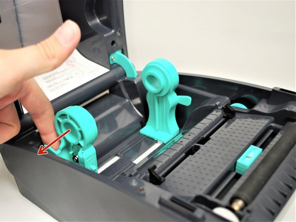 Pull forward on the green Top Cover Open Levers on either side of the printer.