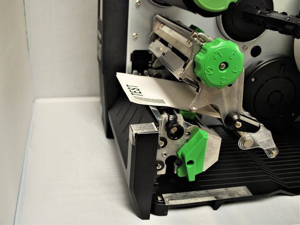 With the other hand, rotate the green print head release lever clockwise.