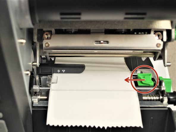Make sure the far edge of the label roll lines up with the clear label guide.