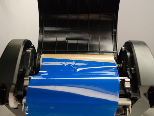 Stick ribbon onto the ribbon rewind paper core.