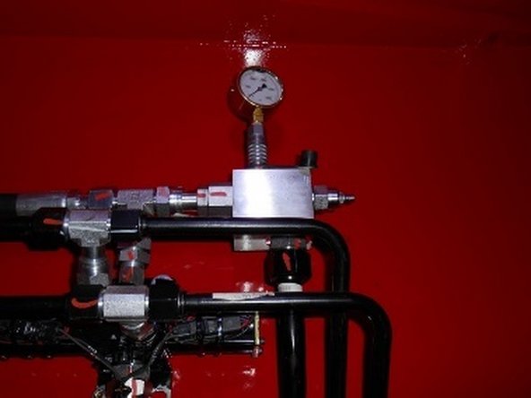 Using the Production Test Procedures, set the carrier relief and hydraulic cooler fan pressures